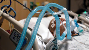 Ventilator tubes are attached a COVID-19 patient at Providence Holy Cross Medical Center in the Mission Hills section of Los Angeles, Thursday, Nov. 19, 2020. (AP Photo/Jae C. Hong)