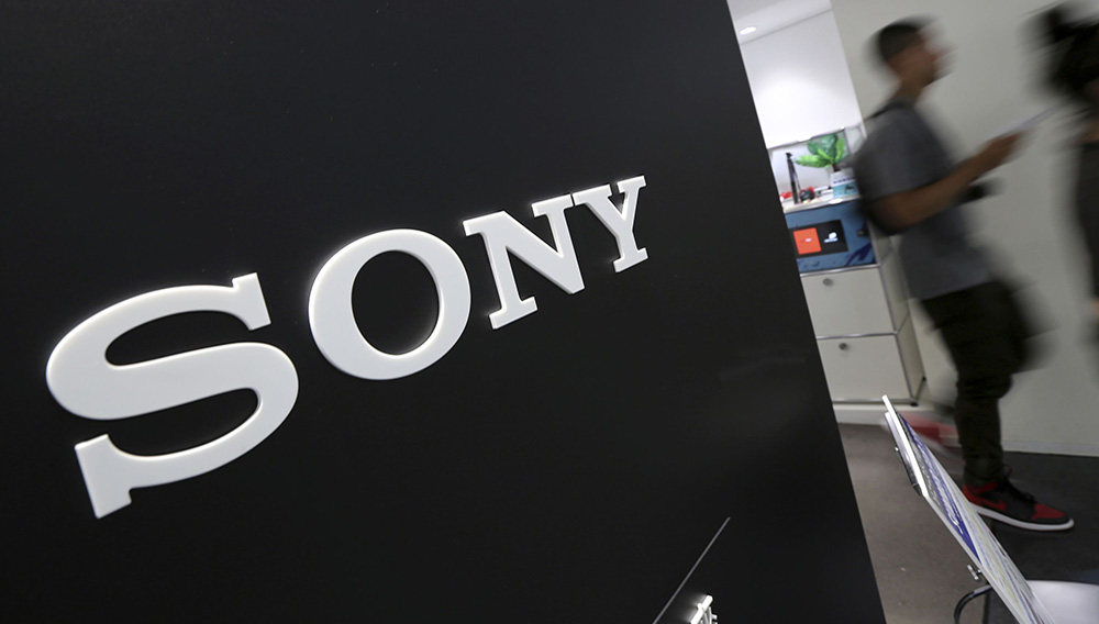 FILE - In this July 31, 2014, file photo, visitors walk past a logo of Sony at Sony Building in Tokyo. Profit at Japanese electronics and entertainment company Sony Corp. more than doubled in the last quarter on healthy gains in its video game sector, as people stayed home during the pandemic. (AP Photo/Eugene Hoshiko, File)