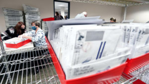 In this Nov. 5, 2020, photo, Lehigh County workers count ballots as vote counting in the general election continues in Allentown, Pa. (AP Photo/Mary Altaffer)