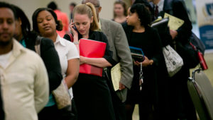Job seekers wait in a line at a career fair in Arlington, Va. PHOTOGRAPH BY ANDREW HARRER — BLOOMBERG/GETTY IMAGES