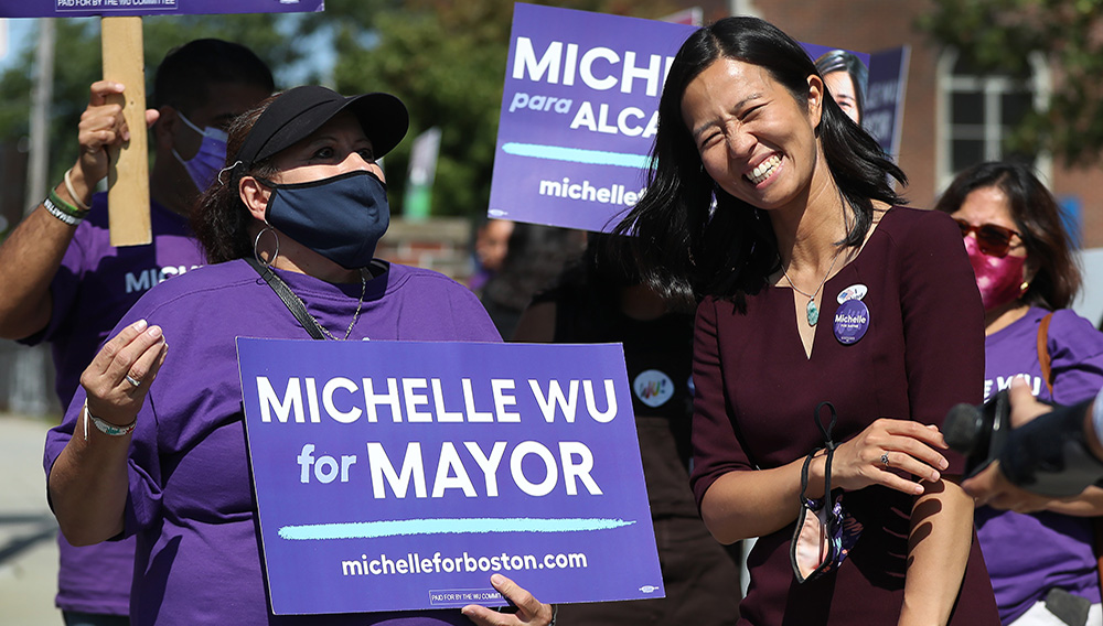 Mayoral candidate Michelle Wu shares a laugh with supporters outside a poling place on Election Day on September 14, 2021 in East Boston, MA. (Staff Photo By Nancy Lane/MediaNews Group/Boston Herald)