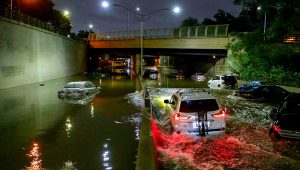 Floodwater surrounds vehicles after heavy rain on an expressway. | AFP/Getty Images