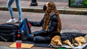 Homeless woman and dog at Downtown Crossing. Stan Grossfeld / The Boston Globe