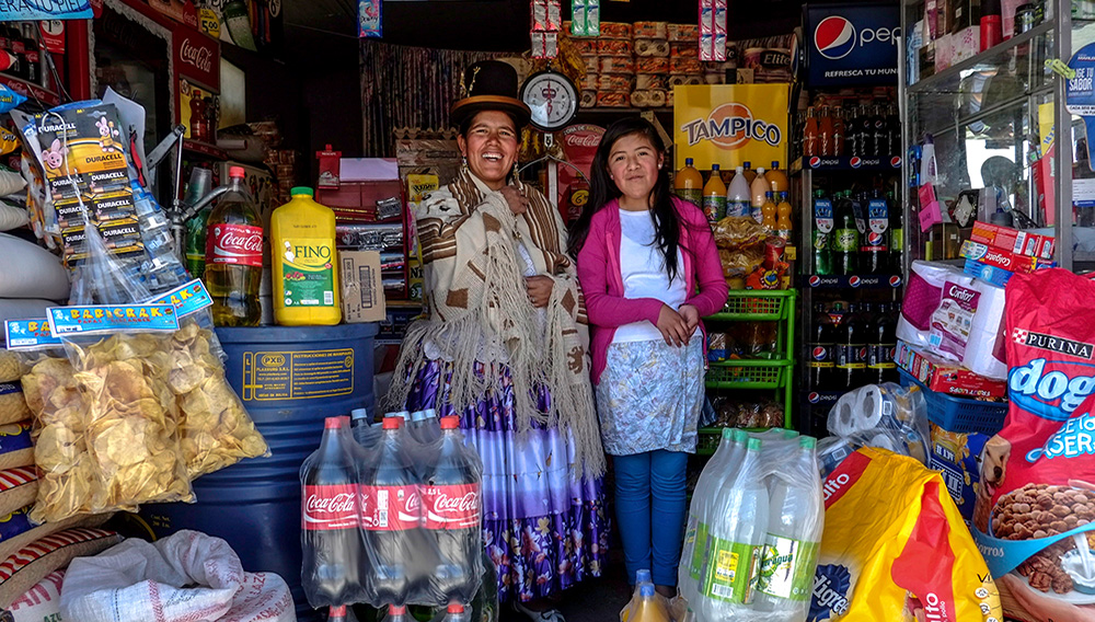File photo of Lucia Mayta, 43, and her daughter Luz Cecilia, 12, posing for a photograph inside their bodega in La Paz, Bolivia, February 24, 2014. David Mercado / Reuters