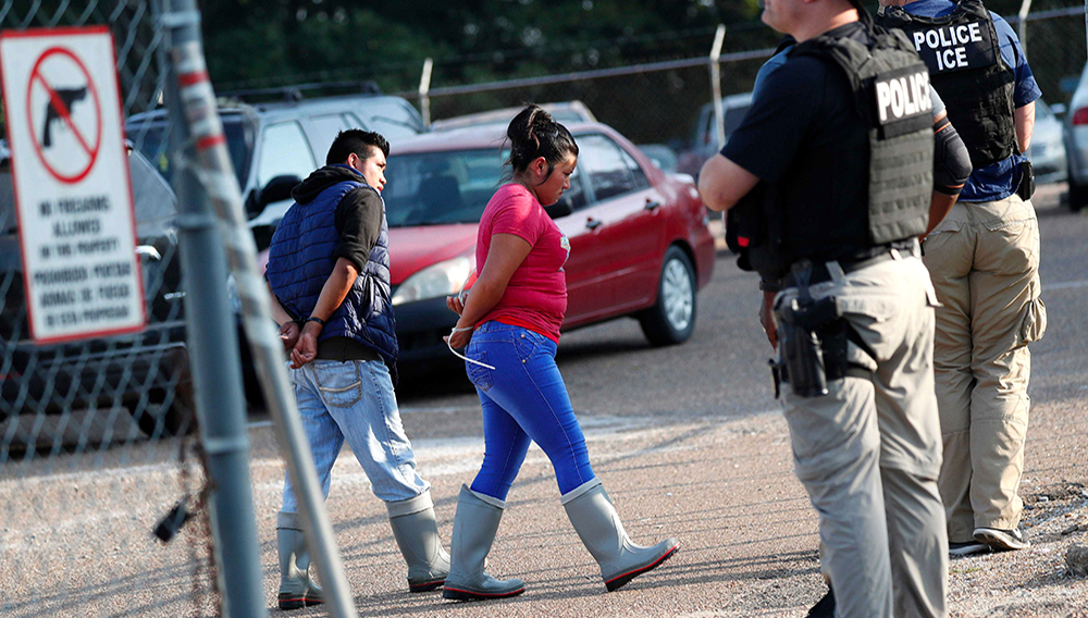 Two people are taken into custody at a Koch Foods Inc. plant in Morton, Miss., on Wednesday, Aug. 7, 2019. | PHOTO: Rogelio V. Solis, AP
