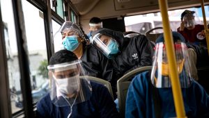 Commuters, wearing protective face masks and face shields, travel on a public bus in Lima, Peru, Wednesday, July 22, 2020. (AP Photo/Rodrigo Abd)