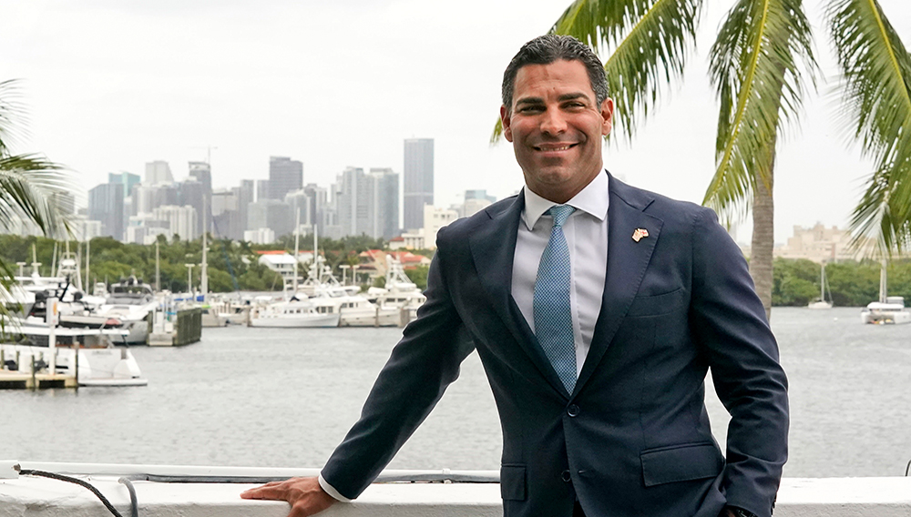 Miami Mayor Francis Suarez poses for a photo with the Miami skyline, Friday, Oct. 29, 2021, at City Hall in Miami. (AP Photo/Wilfredo Lee)