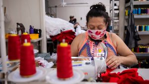 Seamstress Brenda Flores makes baby bloomers while wearing a mask at T&Q Cutting Services on May 2, 2020 in Dallas. (Juan Figueroa / Staff Photographer)