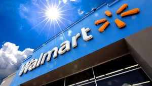 FILE - This June 25, 2019, file photo shows the entrance to a Walmart in Pittsburgh. Walmart is reporting disappointing fourth-quarter profits and sales. The nation's largest retailer says that sales at its U.S. stores heading into the holiday season were weaker than expected. It also said that social unrest in Chile hurt its business. (AP Photo/Gene J. Puskar, File)