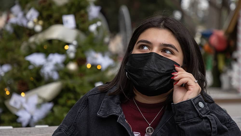 Wendy Gomez, 20, a San Jose State University student, talks about the COVID-19 omicron variant at Christmas in the Park on Saturday, Dec. 4, 2021, in San Jose, Calif. (Photo by Jim Gensheimer)