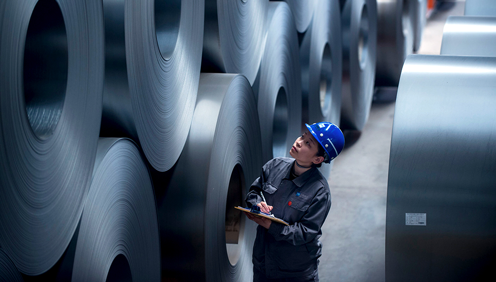 A worker checks rolled steel sheet at HBIS Tangsteel. | PHOTO: worldsteel/Shawn Koh