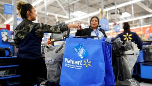 A customer pays for her groceries after shopping at a Walmart store ahead of the Thanksgiving holiday in Chicago. | PHOTO: Kamil Krzaczynski | Reuters