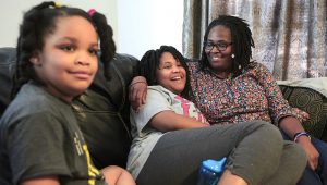 PHOTO: Deleah Payne, 12, center, spends time with her mother Delisa, right, and 6-year-old sister Delynn, left, as they watch movie clips on their living room television in Evansville, Ind., Tuesday evening, Aug. 27, 2019. Deleah and Delynn were both diagnosed with autism. (Sam Owens/Evansville Courier & Press via AP, File)