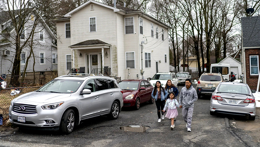 Ecuadorian migrant Klever Ortega, right, leaves home for a shopping trip with members of his family, Saturday, March. 3, 2023, in Spring Valley, N.Y. (AP Photo/Eduardo Munoz Alvarez)