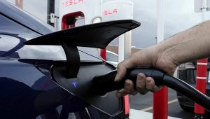 A motorist charges his electric vehicle at a Tesla Supercharger station in Detroit, Wednesday, Nov. 16, 2022. (AP Photo/Paul Sancya, File)