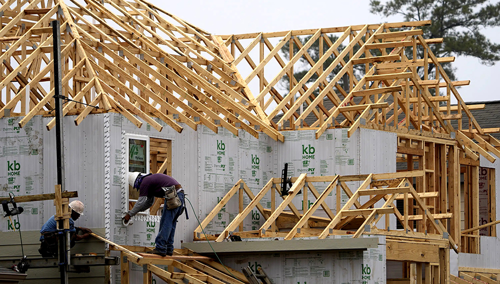Construction workers build a new home on, March 15, 2021, in Houston. Homebuilder stocks are on a tear as investors bet that a dearth of previously occupied homes on the market and moderating mortgage rates will boost builders' prospects in the spring homebuying season. (AP Photo/David J. Phillip)