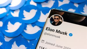 Elon Musk's Twitter profile is seen on a smartphone placed on printed Twitter logos in this picture illustration taken April 28, 2022. REUTERS/Dado Ruvic
