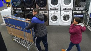 People shop at a Best Buy store Friday, Nov. 26, 2021, in Overland Park, Kan. (Charlie Riedel, The Associated Press)