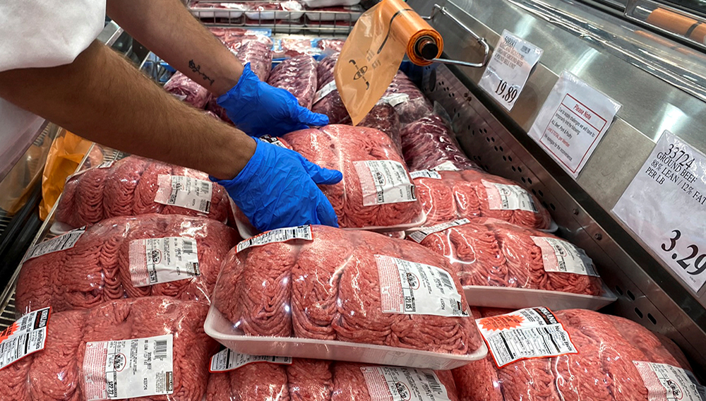 A worker stacks packets of ground beef in the meat section of a Costco warehouse club during the coronavirus disease (COVID-19) pandemic in Webster, Texas, U.S., May 5, 2020. REUTERS/Adrees Latif