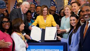 House Speaker Nancy Pelosi of Calif., and the House Democrats with her, celebrate after Pelosi signed the Inflation Reduction Act of 2022 during a bill enrollment ceremony on Capitol Hill in Washington, Aug. 12, 2022. (AP Photo/Susan Walsh)
