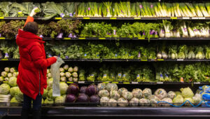PHOTO: A person shops for vegetables at a supermarket in Manhattan, New York City, U.S., March 28, 2022. REUTERS/Andrew Kelly