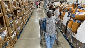 PHOTO: Shoppers look over blankets on sale in a Costco warehouse on Aug. 24, 2023, in Sheridan, Colo. (AP Photo/David Zalubowski)