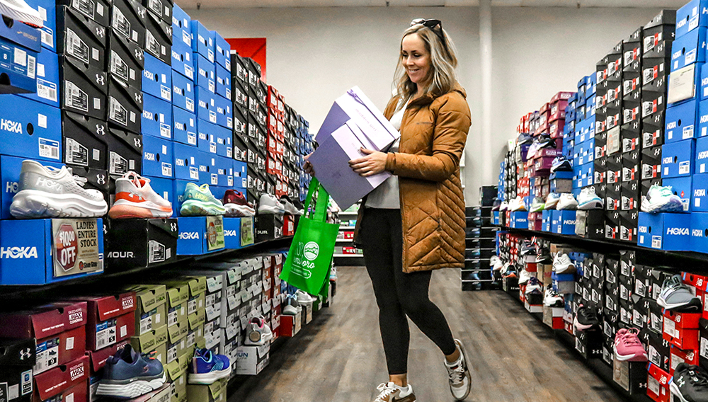 Ashley Crafton looks at tennis shoes at at Shoe Stop while shopping during Small Business Saturday in Wesleyan Park Plaza on Nov. 25, 2023, in Owensboro, Ky. (Greg Eans/The Messenger-Inquirer via AP)