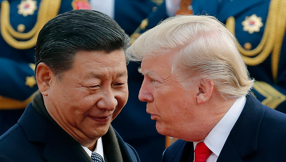 U.S. President Donald Trump, right, chats with Chinese President Xi Jinping during a welcome ceremony at the Great Hall of the People in Beijing on Nov. 9, 2017. (AP Photo/Andy Wong)
