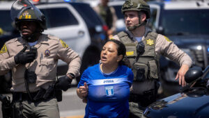 Los Angeles County Sheriff's deputies detain a woman during a standoff by protesters and law enforcement, following multiple detentions by U.S. Immigration and Customs Enforcement in Compton, Calif., June 7, 2025. (OSV News photo/Barbara Davidson, Reuters)