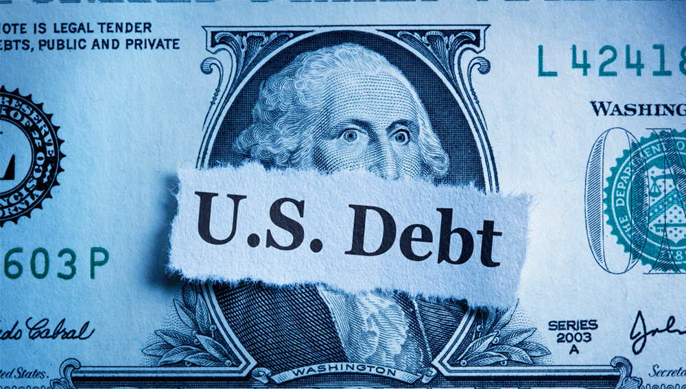 A torn piece of paper warning one to "Uh Oh!!" rests on top of a U.S. one dollar bill as a result of a falling dollar. | Getty Images/iStockphoto