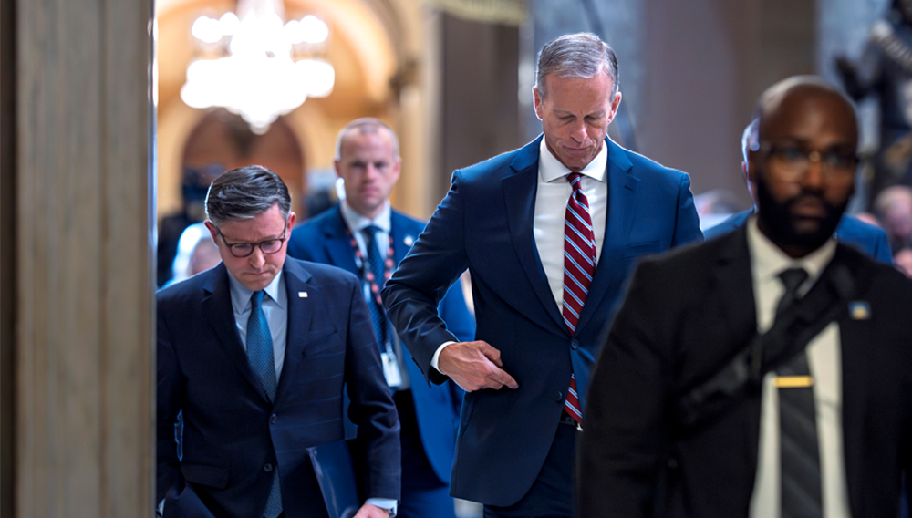 Speaker of the House Mike Johnson, R-La., left, and Senate Majority Leader John Thune, R-S.D., return to their offices after speaking with reporters on the third day of the government shutdown, at the Capitol in Washington, Friday, Oct. 3, 2025. (AP Photo/J. Scott Applewhite)