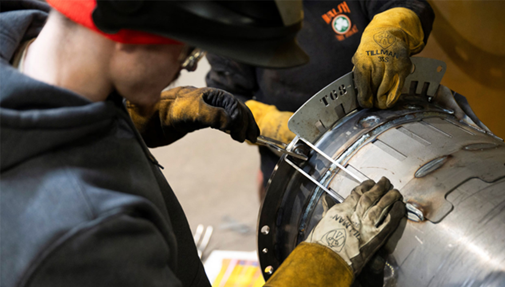 Workers prepare to weld a steel tube at HCC, a company that uses parts to make combines, at the factory in Mendota, Illinois, U.S., February 21, 2025. REUTERS/Vincent Alban