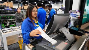 Abril Renteria, an Apple certified advisor, helps a customer check out after their purchase at a Best Buy store, Wednesday, Nov. 26, 2025, in Dallas. (AP Photo/Tony Gutierrez)