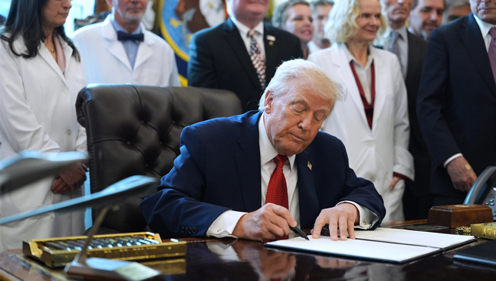 President Donald Trump signs an executive order that could reclassify marijuana as a less dangerous drug at the White House in Washington on December 18, 2025. Evan Vucci / AP