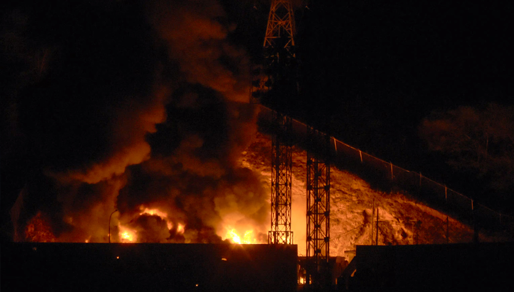 Image of the fire at Fuerte Tiuna, Venezuela’s largest military complex, following a series of explosions in Caracas on January 3, 2026. (Photo by Luis JAIMES / AFP).