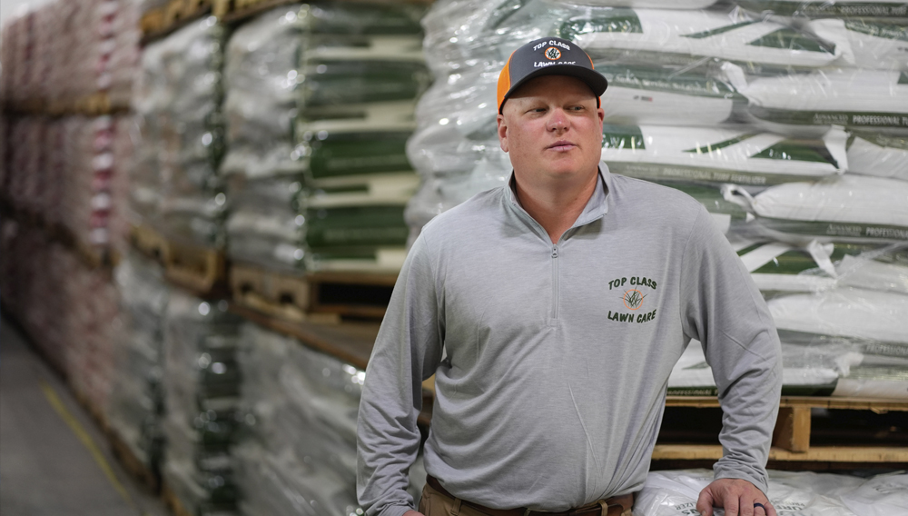 Top Class Lawn Care owner Jake Wilson stands by fertilizer he stockpiled at his supplier’s warehouse in anticipation of Iran war related price hikes Thursday, March 26, 2026, in Riverside, Mo. (AP Photo/Charlie Riedel)