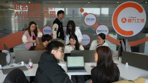 Staff members help their customers install the RedClaw AI software on their laptops in Beijing | Source: The Associated Press.
