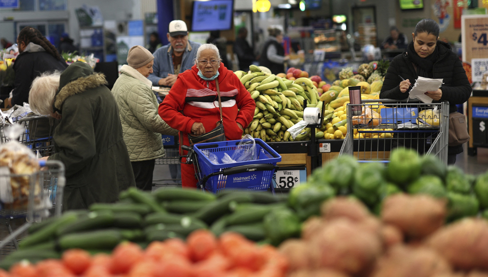 Customers shop for groceries at a Walmart Supercenter retail store in North Bergen, New Jersey, U.S., November 21, 2025. REUTERS/Mike Segar.