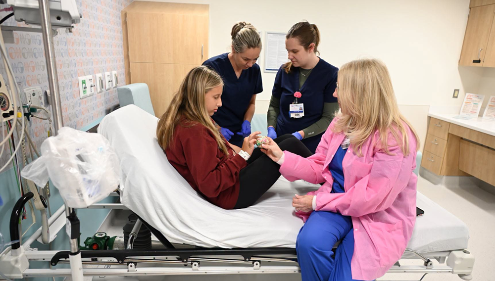 Photo: Members of the BMSCH’s Child Life and Nursing teams care for a patient in BMSCH’s Same Day Services Center.