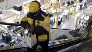 A Meituan delivery worker picks up a food order at a shopping mall in Beijing, China, October 17, 2024. REUTERS/Florence Lo.